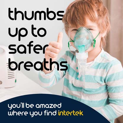 A young boy giving a thumbs up signal while wearing a breathing apparatus